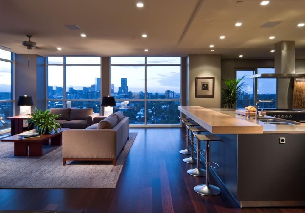 Luxury high-rise apartment living area with city views at dusk