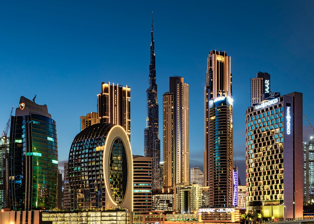 Business Bay skyline at night with Burj Khalifa and illuminated towers